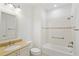 Bathroom featuring a beige countertop, white cabinets, and a tiled shower with bathtub at 8932 Sw 101St Cir, Ocala, FL 34481