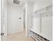 Bright hallway features built-in shelving, hooks, and neutral colored walls at 8932 Sw 101St Cir, Ocala, FL 34481
