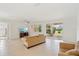 Bright living room featuring neutral walls, tile flooring, a ceiling fan, and a sliding glass door to the backyard at 8932 Sw 101St Cir, Ocala, FL 34481