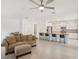 Open-concept living space with modern finishes, kitchen island and tile floors at 8932 Sw 101St Cir, Ocala, FL 34481