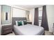 Modern bedroom features recessed art lighting, gray bedding, and a bright, airy feel at 8944 Sydney Ave, Kissimmee, FL 34747