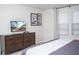 Bedroom features a television mounted above a wooden dresser and a large window at 8944 Sydney Ave, Kissimmee, FL 34747