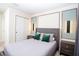 Modern bedroom showcases stylish lighting, chic gray bedding, and matching nightstands at 8944 Sydney Ave, Kissimmee, FL 34747