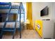 Unique ' bedroom boasts blue bunkbeds, a minion themed cabinet, and a TV at 8944 Sydney Ave, Kissimmee, FL 34747