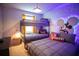 Fun bedroom with bunk beds, accent lighting, and playful Mickey Mouse themed wallpaper at 8944 Sydney Ave, Kissimmee, FL 34747