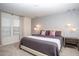 Spacious bedroom features a large bed, stylish lighting, and two windows at 8944 Sydney Ave, Kissimmee, FL 34747
