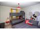 Fun bedroom with bunk beds, accent lighting, and playful Mickey Mouse themed wallpaper at 8944 Sydney Ave, Kissimmee, FL 34747
