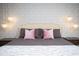Elegant bedroom featuring a king-sized bed, decorative pillows and stylish lighting fixtures at 8944 Sydney Ave, Kissimmee, FL 34747