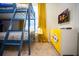 Unique ' bedroom boasts blue bunkbeds, a minion themed cabinet, and a TV at 8944 Sydney Ave, Kissimmee, FL 34747