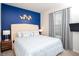 This bedroom features a blue accent wall, decorative art, and a bright, airy feel at 8944 Sydney Ave, Kissimmee, FL 34747