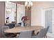 Contemporary dining room with a sleek table, stylish chairs, and modern lighting at 8944 Sydney Ave, Kissimmee, FL 34747