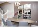 Elegant dining room with a long oval table, six chairs, modern lighting, and large decorative mirrors at 8944 Sydney Ave, Kissimmee, FL 34747