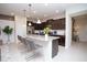 Modern kitchen featuring dark cabinetry, stainless steel appliances, granite countertops, and an island with seating at 8944 Sydney Ave, Kissimmee, FL 34747