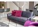 Comfortable living room with a plush sofa, decorative pillows, and a view of the staircase at 8944 Sydney Ave, Kissimmee, FL 34747