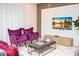 Living room showcases modern decor, including bold armchairs and a mounted TV at 8944 Sydney Ave, Kissimmee, FL 34747