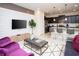 Modern living room with a textured accent wall, comfortable seating, and an open layout to the kitchen at 8944 Sydney Ave, Kissimmee, FL 34747