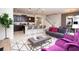 Open-concept living space with sleek furniture, connecting kitchen, dining, and living areas at 8944 Sydney Ave, Kissimmee, FL 34747