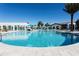 Resort style pool has lounge chairs, umbrellas and a restaurant at 8944 Sydney Ave, Kissimmee, FL 34747