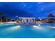 Night shot of the pool and water park in this community with seating and umbrellas at 8944 Sydney Ave, Kissimmee, FL 34747