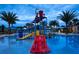 Night shot of the water park in this community with slides, water features and a pool at 8944 Sydney Ave, Kissimmee, FL 34747