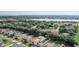 Aerial view showing the home's location near a lake and surrounded by lush greenery in a desirable neighborhood at 10231 Lenox St, Clermont, FL 34711