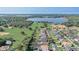 Scenic aerial shot displaying the neighborhood's proximity to a large lake and lush green fields at 10231 Lenox St, Clermont, FL 34711