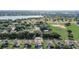 Aerial view showcasing the home's proximity to a lake and lush surroundings in a quiet, residential area at 10231 Lenox St, Clermont, FL 34711