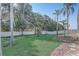 Well-manicured backyard featuring lush lawn, decorative rock beds, mature trees and a storage shed at 10231 Lenox St, Clermont, FL 34711