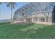 Expansive backyard features lush green lawn and screened enclosure ensuring endless outdoor possibilities at 10231 Lenox St, Clermont, FL 34711
