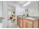 Bright bathroom with double vanity leading to bedroom with neutral accents and natural light at 10231 Lenox St, Clermont, FL 34711