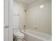 Bathroom featuring a toilet and tub with a tiled shower at 10231 Lenox St, Clermont, FL 34711