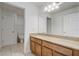 Bathroom features a sink with granite countertops and a mirror at 10231 Lenox St, Clermont, FL 34711