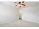 Bedroom includes a ceiling fan and a door leading to the rest of the home at 10231 Lenox St, Clermont, FL 34711