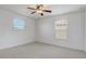 Bright bedroom with a ceiling fan and two windows bringing in natural light at 10231 Lenox St, Clermont, FL 34711