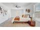 Inviting primary bedroom showcasing a cozy bed with neutral bedding, a ceiling fan, and ample natural light at 10231 Lenox St, Clermont, FL 34711