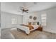 Relaxing primary bedroom with ceiling fan, decorative wall art, plush bedding and ample natural light at 10231 Lenox St, Clermont, FL 34711
