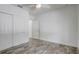Bedroom showcasing wood-look floors, a double closet, and natural light from an open door at 10231 Lenox St, Clermont, FL 34711