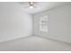 Spacious bedroom featuring a ceiling fan and window bringing in natural light at 10231 Lenox St, Clermont, FL 34711