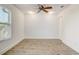 Bright bedroom featuring wood-look floors, a ceiling fan, and natural light from a window at 10231 Lenox St, Clermont, FL 34711