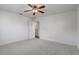 This bedroom includes a ceiling fan and has an open door to the rest of the home at 10231 Lenox St, Clermont, FL 34711