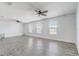 Large bonus room with wood-look floors, ceiling fans, and bright windows with natural light at 10231 Lenox St, Clermont, FL 34711