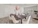 Elegant dining area with a modern table, seamlessly connecting to a bright living area, perfect for gatherings at 10231 Lenox St, Clermont, FL 34711