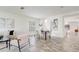 Open dining area with a modern table set, flowing into the living room, filled with natural light at 10231 Lenox St, Clermont, FL 34711