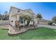 Landscaped front yard of a two-story home with a three-car garage and long paved driveway at 10231 Lenox St, Clermont, FL 34711