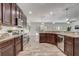Beautiful kitchen featuring stainless steel appliances, wooden cabinets, and a view of the dining and living areas at 10231 Lenox St, Clermont, FL 34711