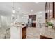 Open concept kitchen featuring granite countertops, stainless steel appliances, and bar stool seating at 10231 Lenox St, Clermont, FL 34711