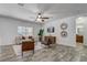 Bright living room featuring a comfortable sofa, stylish decor, a ceiling fan, and wood-look flooring at 10231 Lenox St, Clermont, FL 34711
