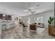 Open-concept living room with a dining area, kitchen bar, hardwood floors and a door that leads to the outside at 10231 Lenox St, Clermont, FL 34711