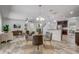 Open-concept living space with modern furnishings, hardwood floors, and a view of the kitchen and dining area at 10231 Lenox St, Clermont, FL 34711