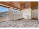 Spacious outdoor kitchen featuring stone tile floor, wood ceiling, white cabinets and a large picture window at 10231 Lenox St, Clermont, FL 34711